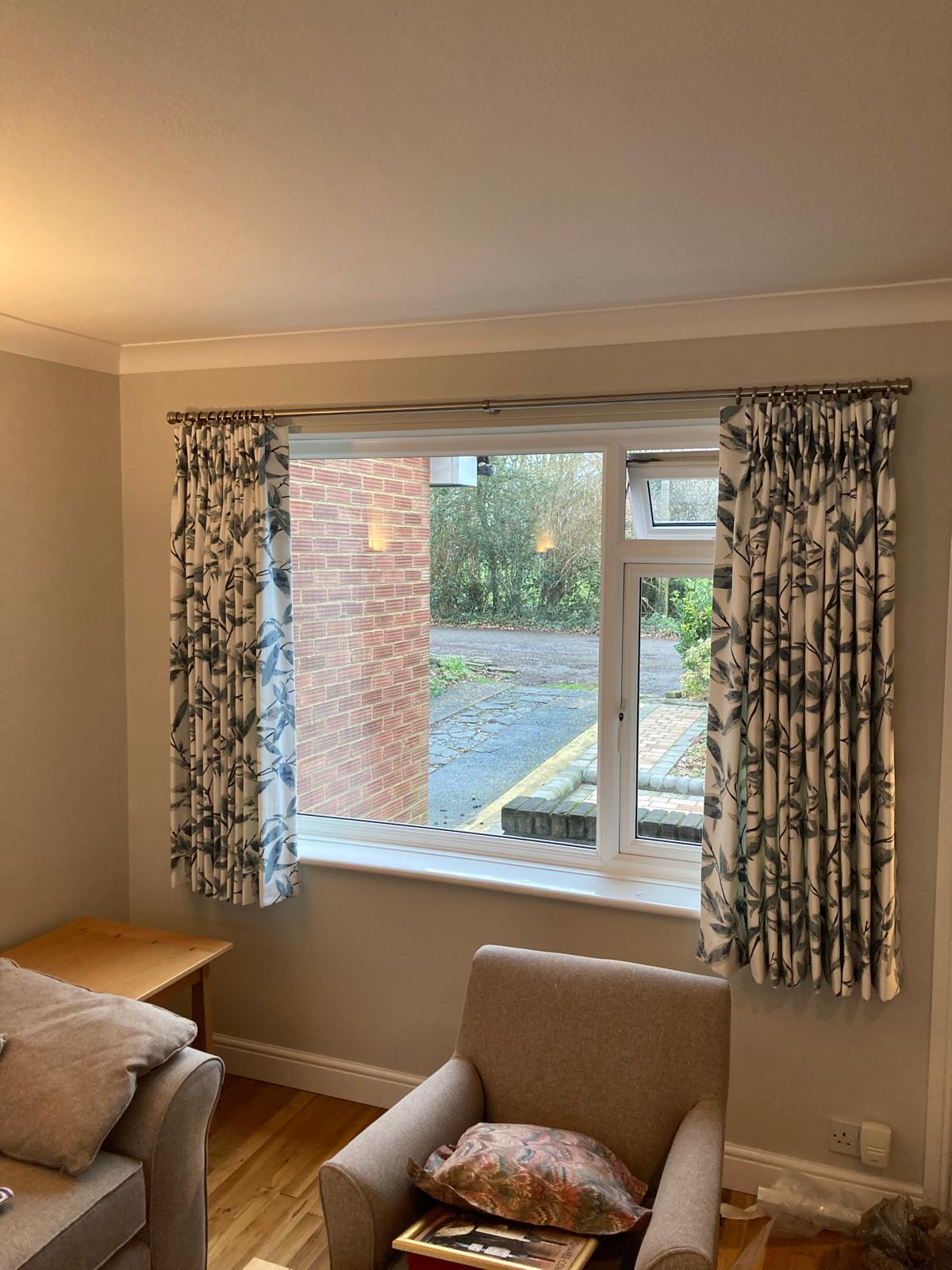 Patterned pinch pleat curtains in a country drawing room