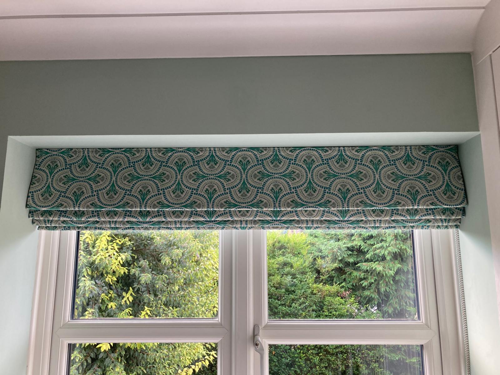 Patterned Roman blind — garden window